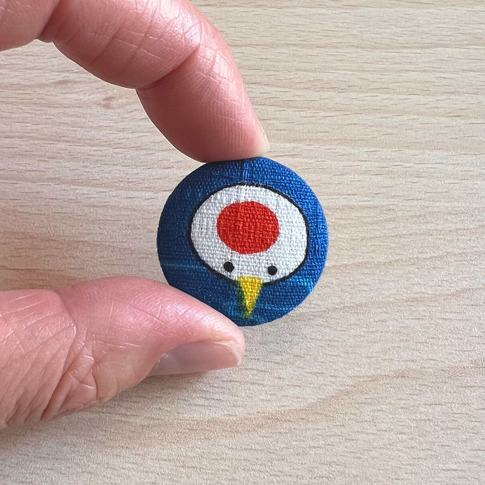 Button blauw kraanvogelkop