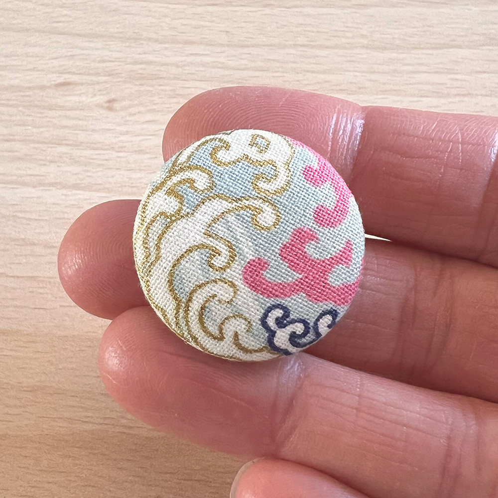 Button lichtblauw golven